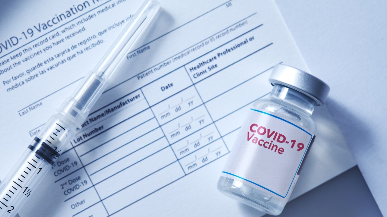 68387853d4910-a-vial-of-coronavirus-vaccine-on-a-vaccination-record-card-with-a-syringe-on-the-side.jpeg